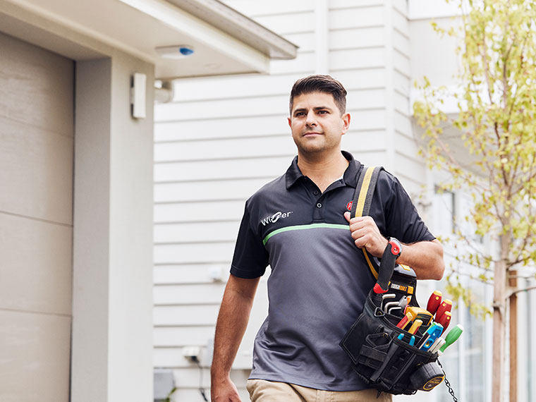 Electrician carrying his tool belt.