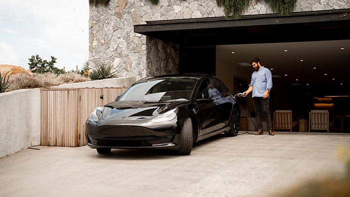 Man charging his vehicle using EV charger