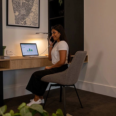 Woman using a phone in the home office