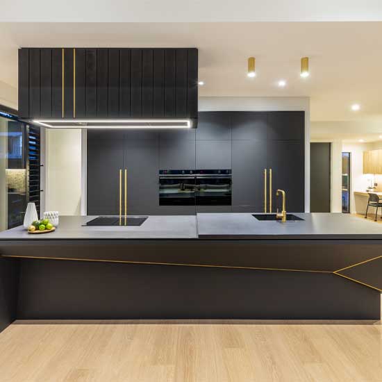 A contemporary kitchen featuring stylish black and gold accents.