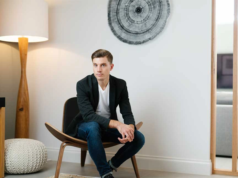 Man comfortably sitting on a chair within a cozy room