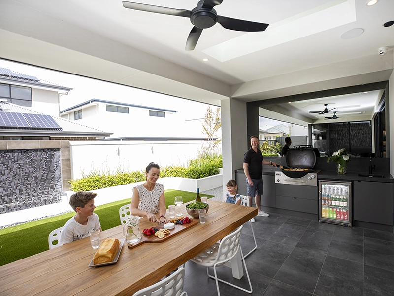 Family preparing lunch in their outdoor living room