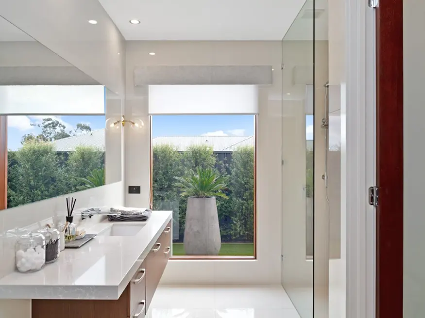 Bathroom vanity with sink and framed mirrors.