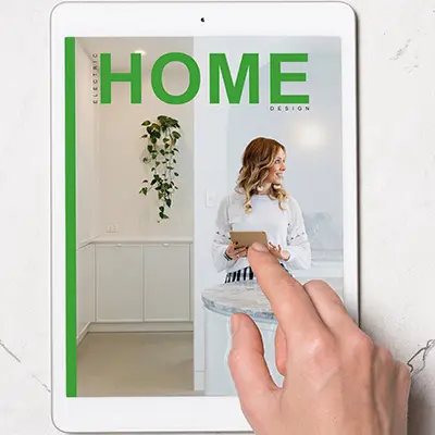 Smiling woman in elegant white dress holding an iPad.