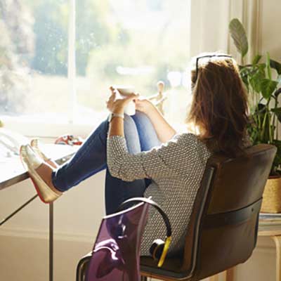 Woman seated at a chair.