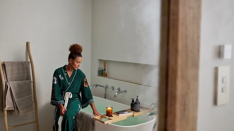 Woman sitting on the bathtub