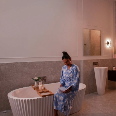 Woman sitting on bathtub