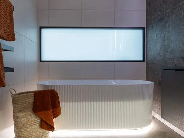 A bathroom with a spacious tub and a window overlooking