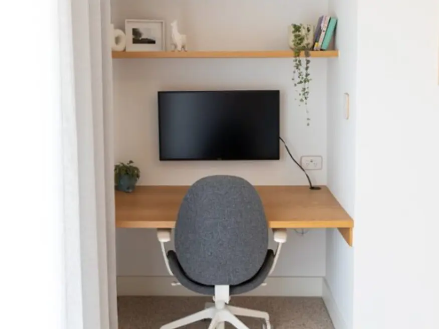 Small room with desk, chair, and monitor.