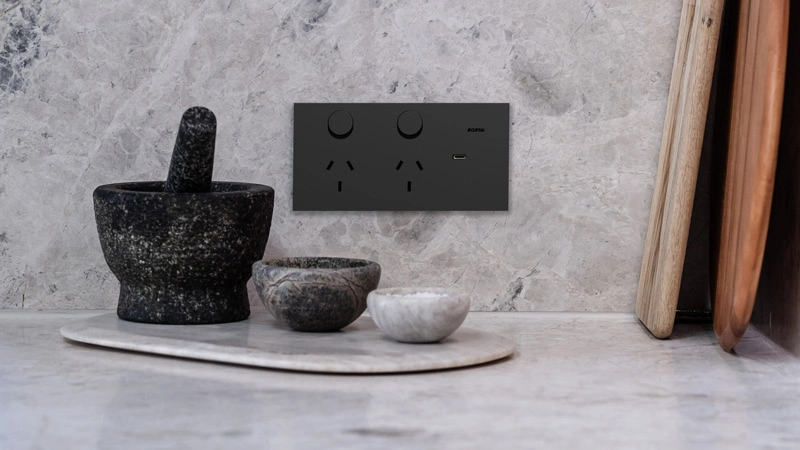 Modern kitchen countertop with stone mortar and pestle and Solis matte black power outlet