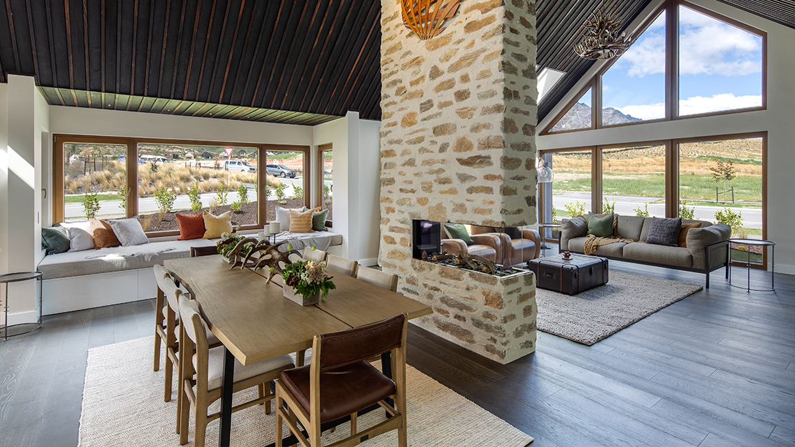 Warm living room with stone fireplace and wooden decor.