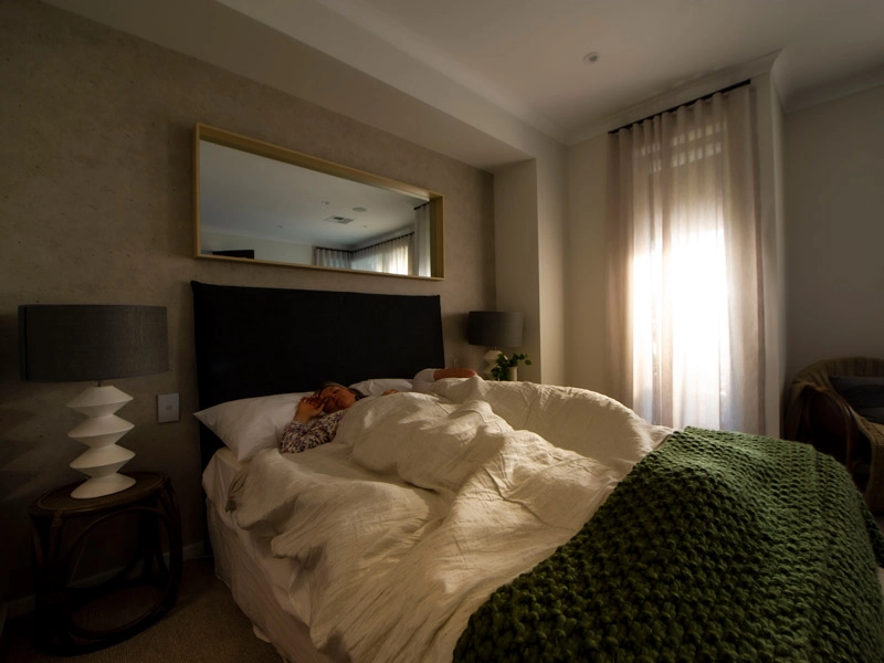 A woman sleeping in a cozy bedroom