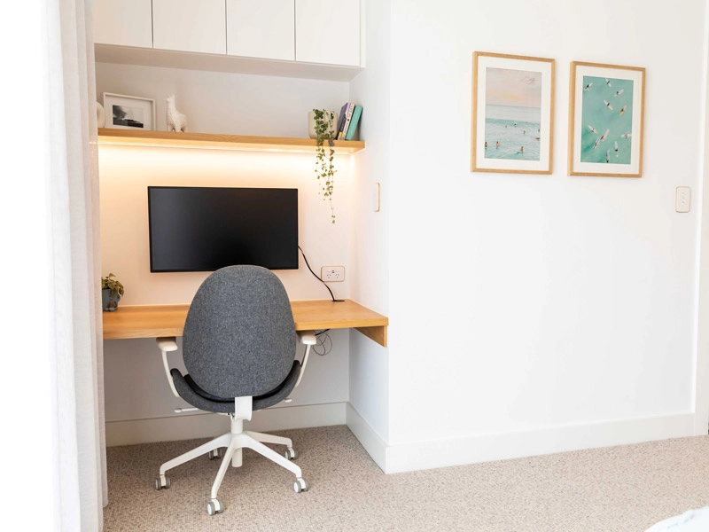 Cozy workspace with computer and chair in small room