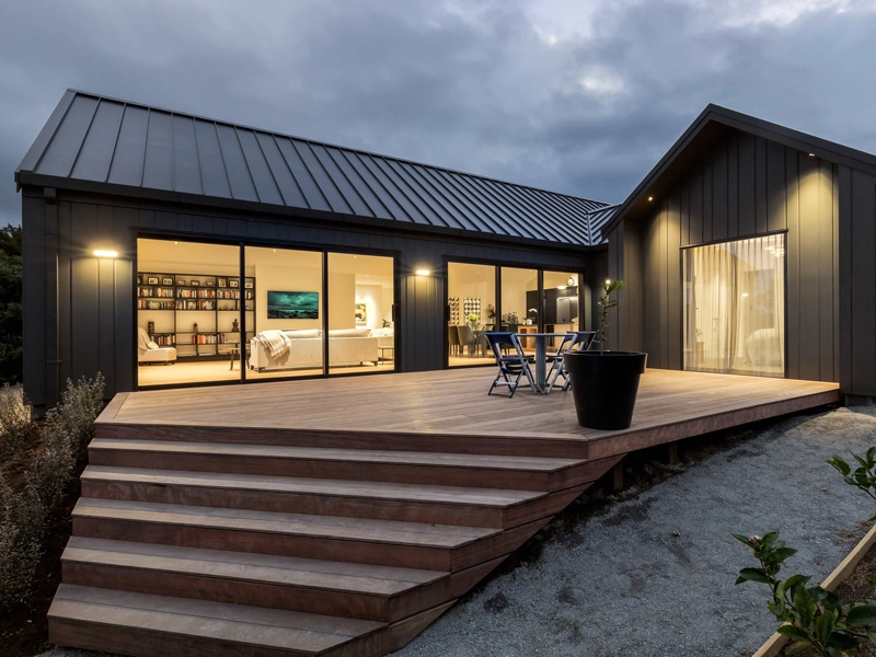 A house with a deck and stairs leading up to it